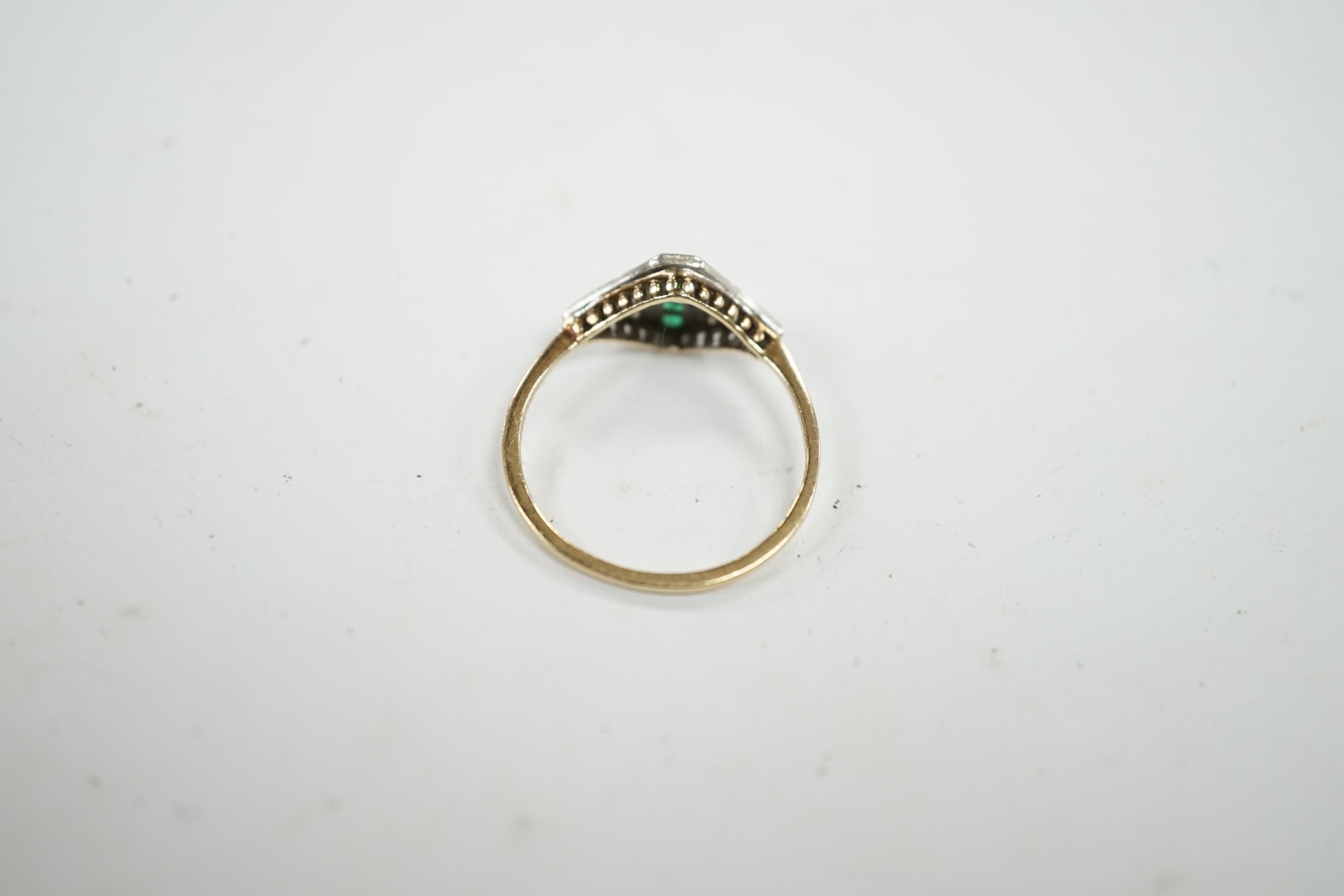 A small early 20th century 15ct, emerald and diamond cluster set ring, size P, gross weight 1.6 grams. Condition - fair